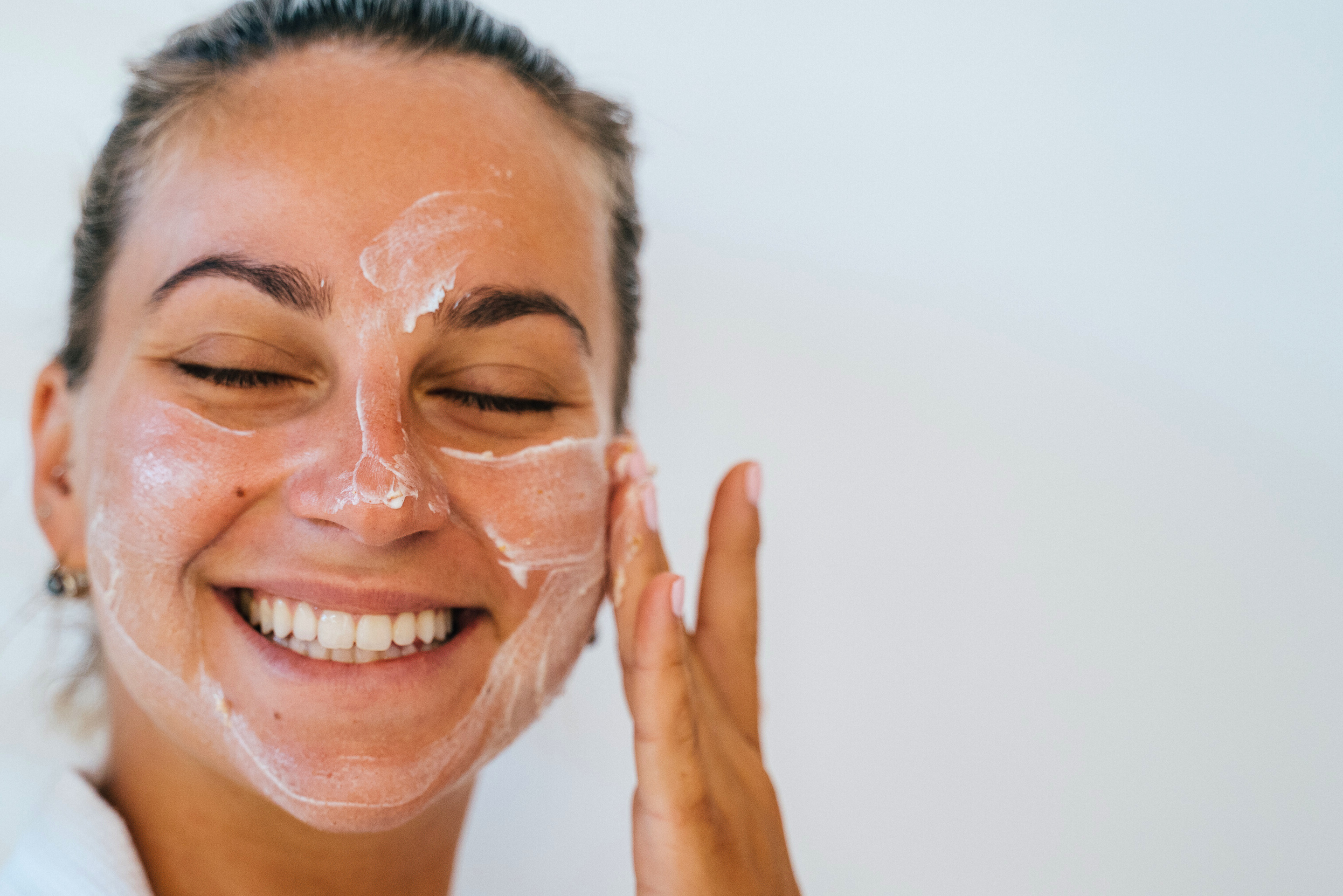 Woman applying a facial mask