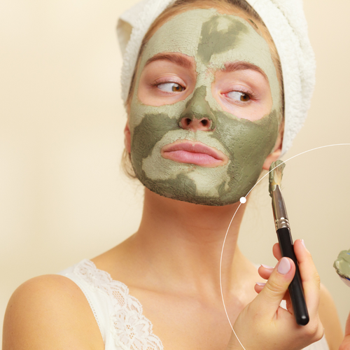 Woman applying a skincare mask
